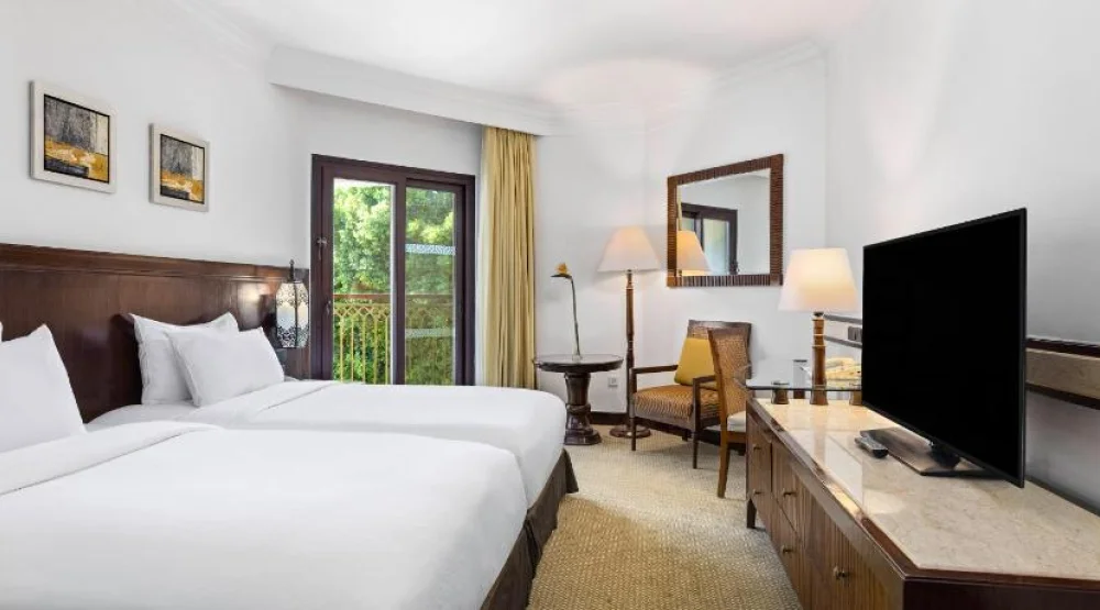 Guest Room Twin Bed/ Living Area at Hilton Luxor Resort & Spa