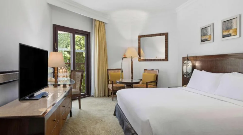 Guest Room King Bed/ Living Area at Hilton Luxor Resort & Spa